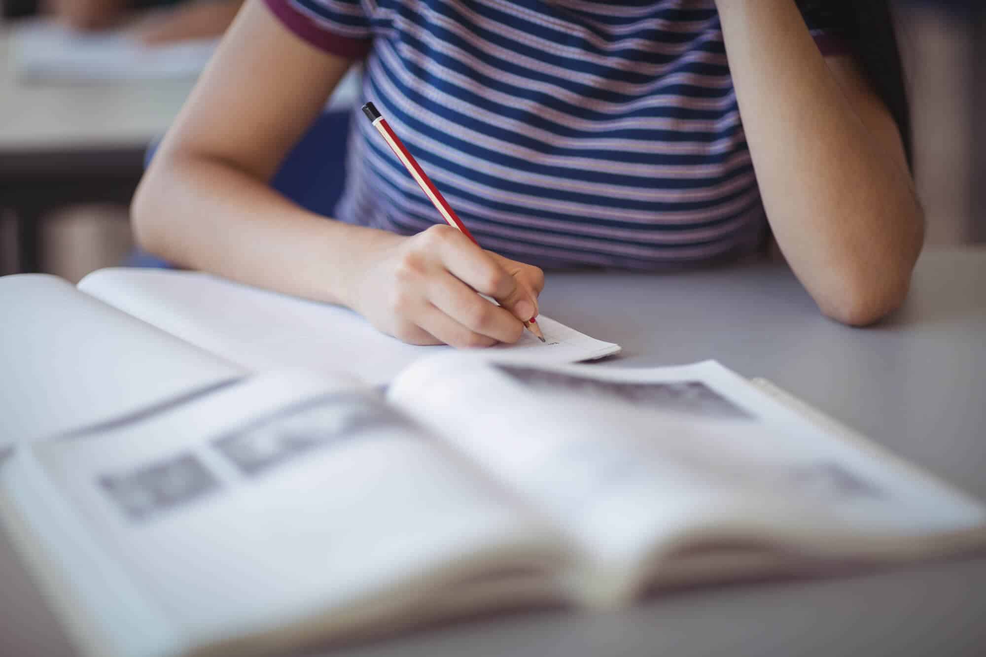 Closeup of schoolgirl studying in classroom