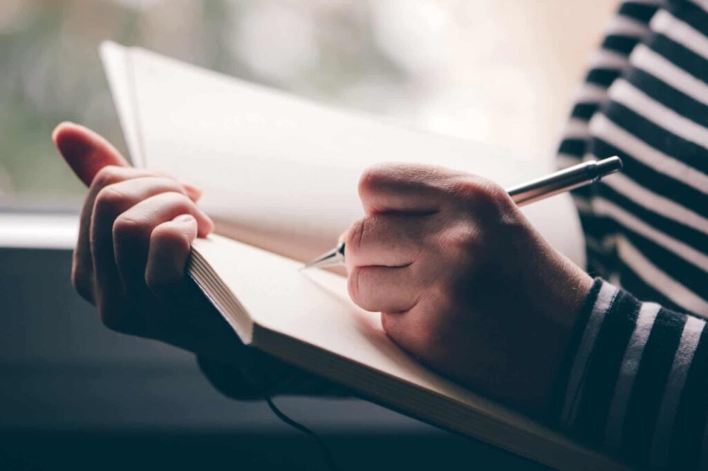 Woman writing in notebook