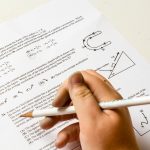 math-homework-close-up-of-hand-with-pencil