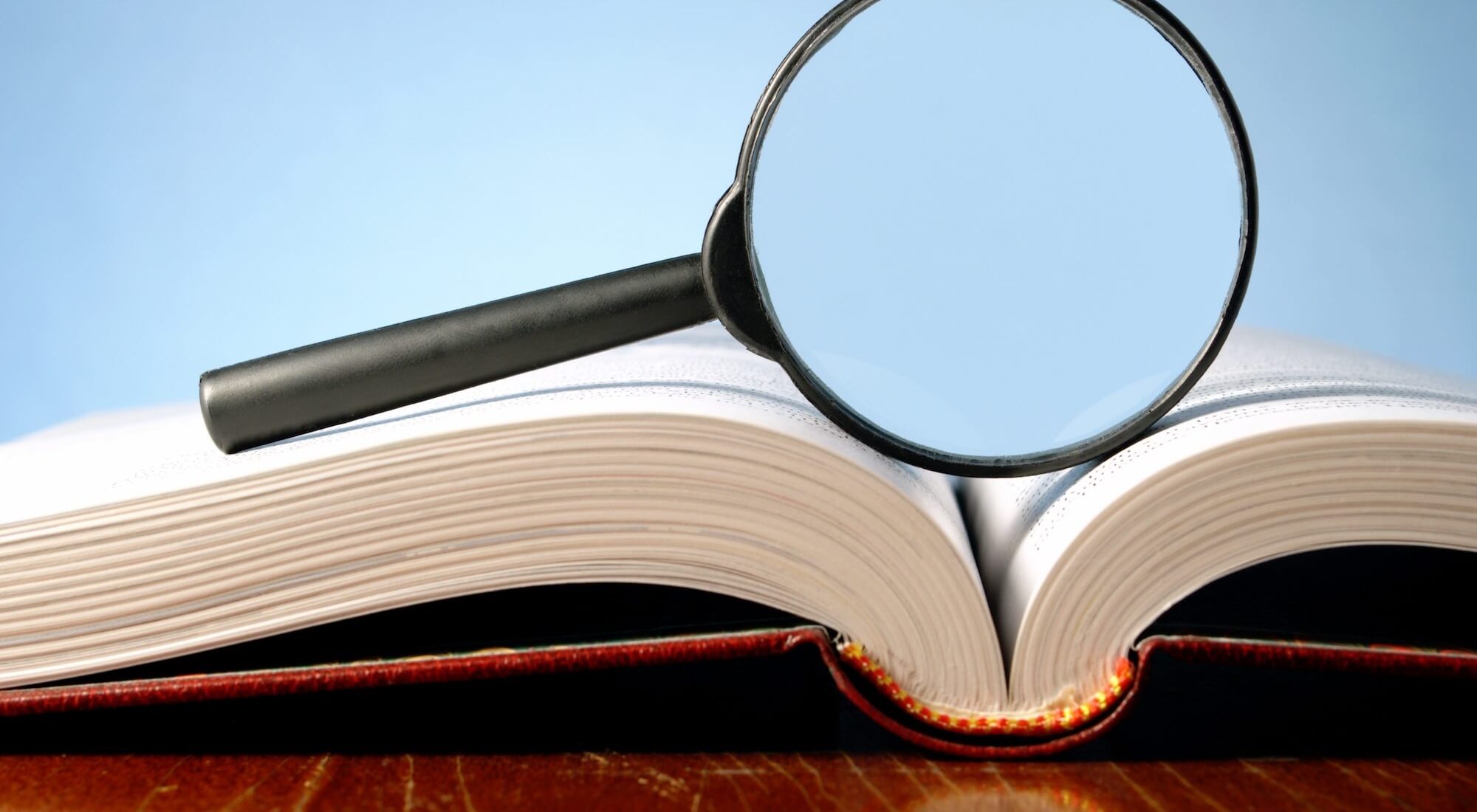 Magnifying glass on book