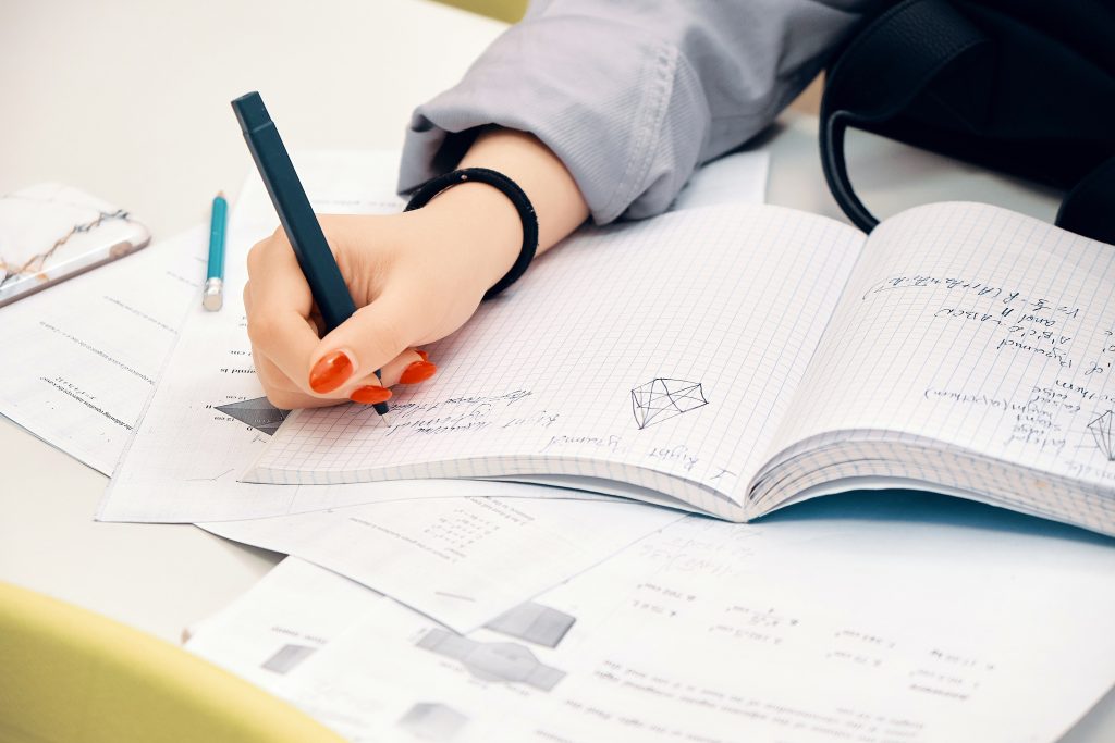 Student with pen and notebook preparing for the ACT exam